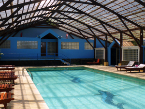 At the far end of the pool are the large tiled dressing rooms. A wide apron surrounds the pool and there is much poolside furniture